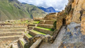 The impressive stone terraces of the Inca archaeological site of Ollantaytambo climbing a steep hillside in Peru's Sacred Valley. – Qosqo Expeditions