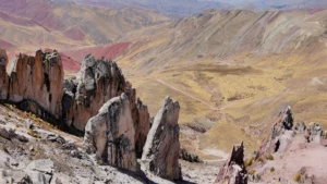 The sharp, jagged rock formations of the Palcoyo Stone Forest, overlooking the colorful, high-altitude Andean landscape near Cusco, Peru. – Qosqo Expeditions