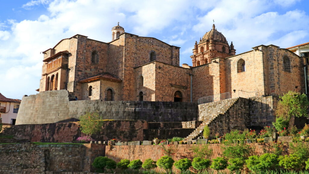 The Coricancha complex in Cusco, showing the perfect Inca stone walls at its base and the Spanish colonial convent built on top, a key site in any Inca mythology guide – Qosqo Expeditions