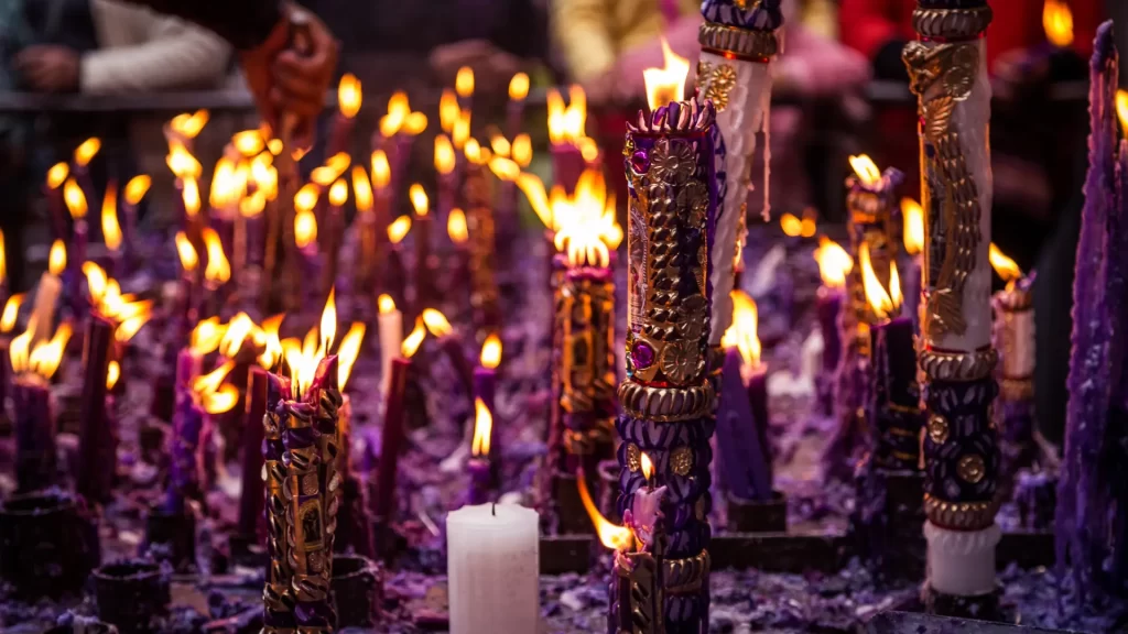 Purple devotional candles lit during the Lord of Miracles celebration in Lima, Peru-Qosqo Expeditions