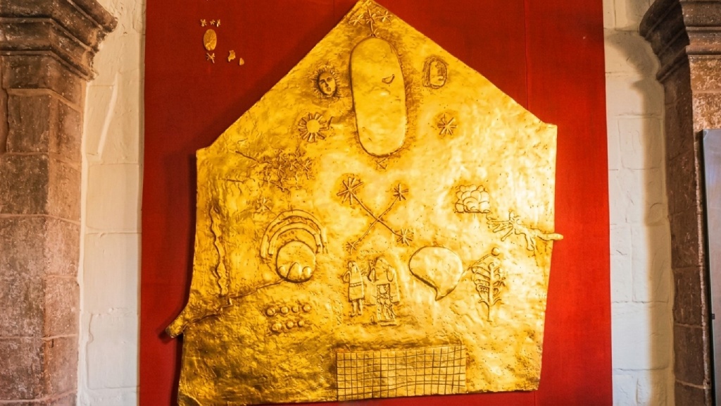 Golden tablet at Qorikancha featuring symbols of the Andean worldview associated with Inca gods.