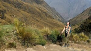 Hiker using trekking poles while climbing Dead Woman’s Pass on the 4 day Inca Trail.