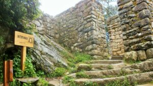 Intipunku (Sun Gate) sign beside stone steps on the Inca Trail.