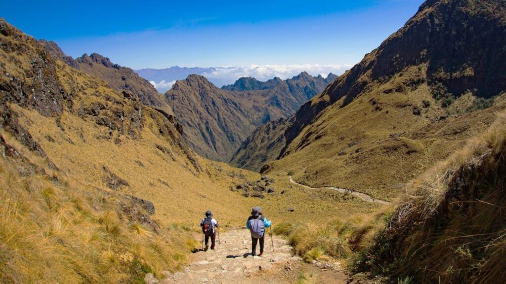 Two hikers descending a steep stone trail during the 4 day Inca Trail.